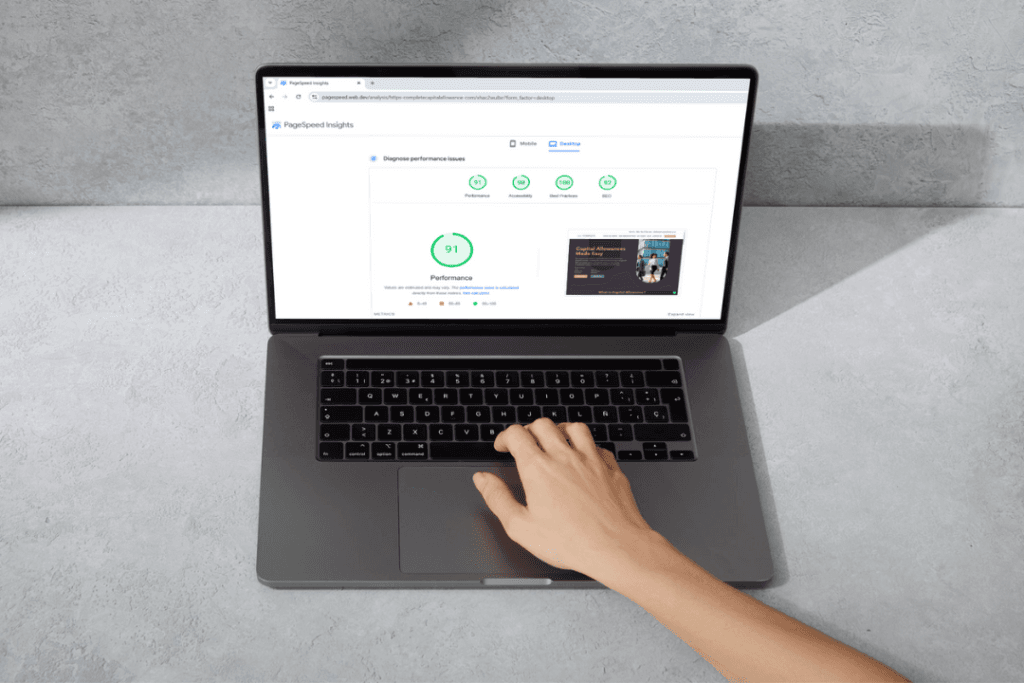Laptop with Google Page Speeds Insights on the screen, there is a hand working on the keyboard.